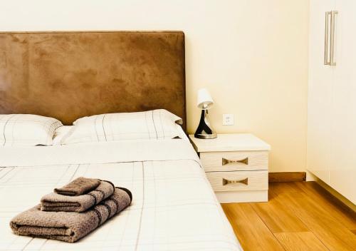 a bedroom with a bed with two towels on it at sea soul house in Athens