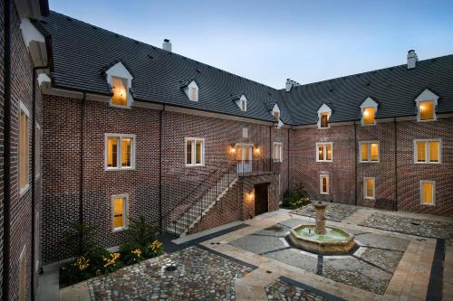 a brick building with a fountain in the courtyard at Wedmore Place in Williamsburg