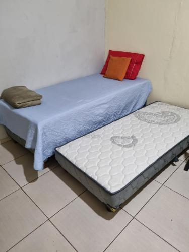 two beds sitting on the floor in a room at Ct galo confins in Vespasiano