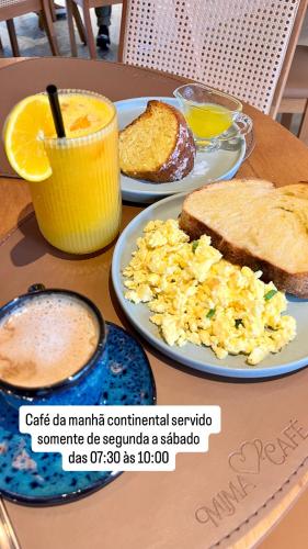 a table topped with plates of eggs and toast at Apartamento Giardino Maia, Café da Manhã cortesia em dias úteis in Guarulhos
