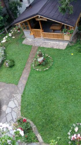 a garden with a gazebo in the background at Holiday Home Tirol in Vlasic