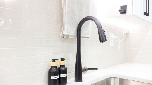 a kitchen sink with two bottles of wine at A true Home away from Home in Calgary