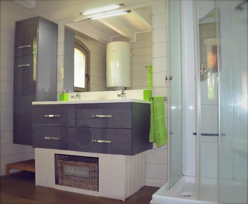 een badkamer met een wastafel en een spiegel bij Chalet Montana - hot tub, sauna, playstation in Durbuy