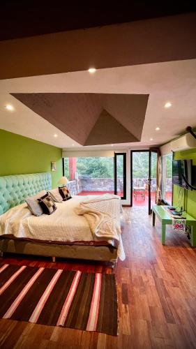 a bedroom with a large bed and a large window at Santuyoc in Volcán