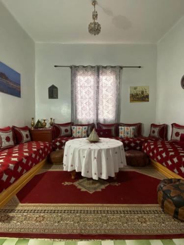 a living room with couches and a table in it at Dar Nassiri in Rabat