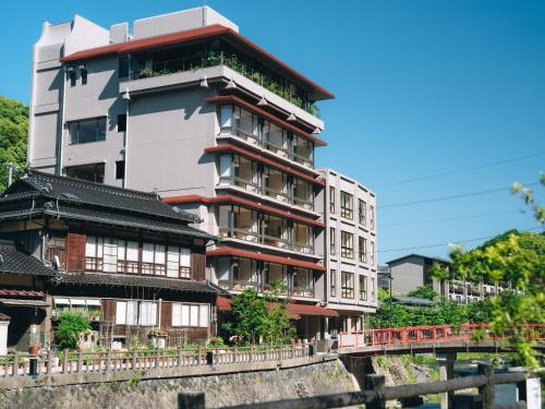a building with balconies on the side of a bridge at SOIL Nagatoyumoto in Nagato