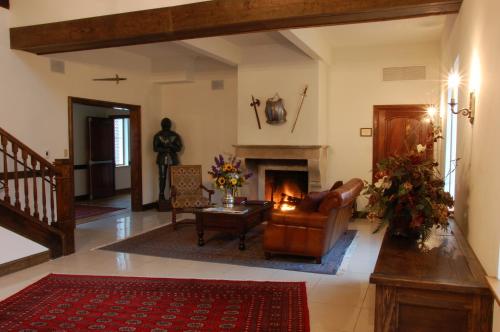 a living room with a couch and a fireplace at Wedmore Place in Williamsburg