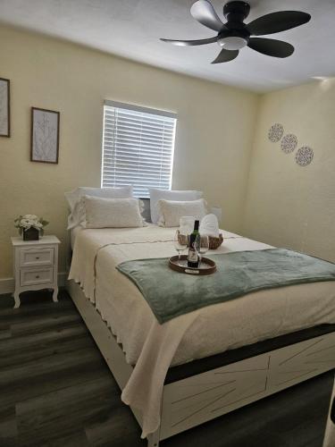 a bedroom with a bed with a ceiling fan at Palmera House in Tampa with Hot Tub 10 minutes from Airport & Busch Gardens in Tampa