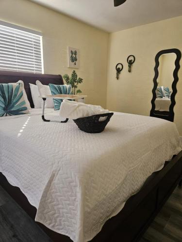 a large white bed with a black bowl on it at Palmera House in Tampa with Hot Tub 10 minutes from Airport & Busch Gardens in Tampa