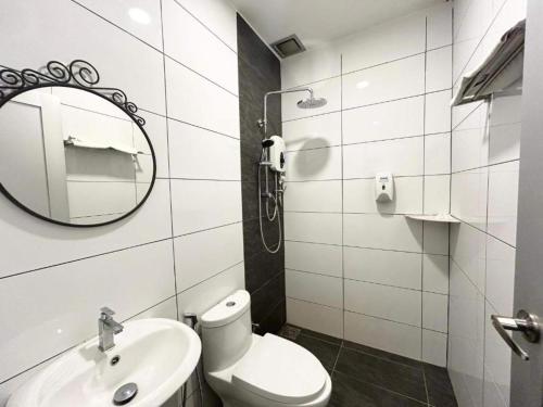 a bathroom with a toilet and a sink and a mirror at Collection O Malacca Near St John's Fort Formerly Gill Garden in Melaka