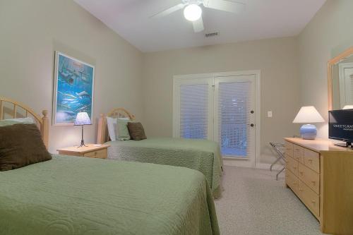 a bedroom with two green beds and a window at SM04: 4 Silver Moss in Kiawah Island