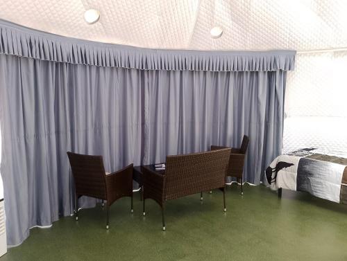 a bedroom with a table and chairs and a bed at Beautiful Dome for a Romantic Glamping Escape with Breathtaking Views in Montana in Plains