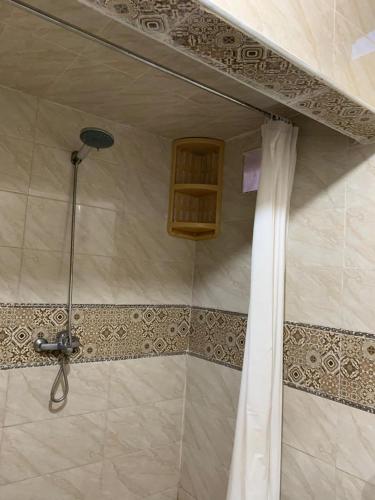 a shower with a shower curtain in a bathroom at Dar Nassiri in Rabat