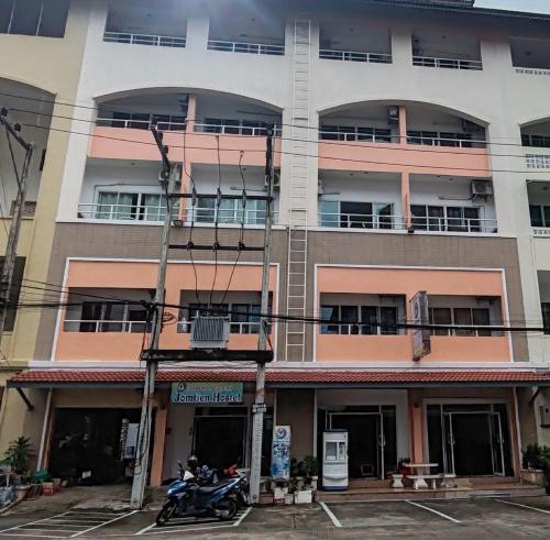 a motorcycle parked in front of a building at Jomtien Hostel in Jomtien Beach