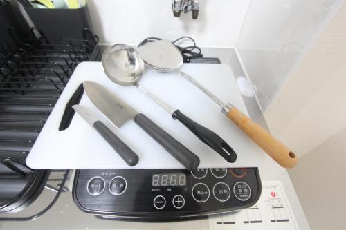 a bunch of kitchen utensils sitting on top of a counter at HOTEL LUANA in IKEBUKURO HIGASHINAGASAKI in Tokyo