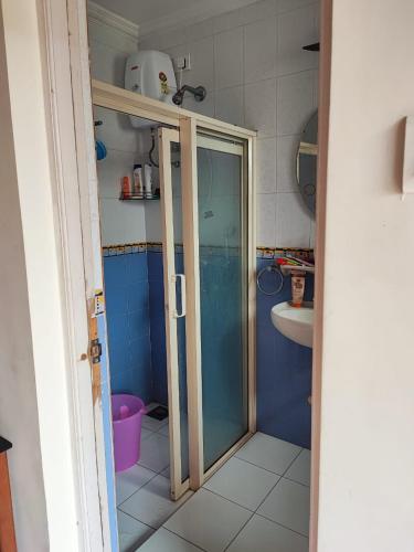 a bathroom with a glass shower and a sink at Villa Candolim Goa in Candolim
