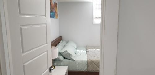 a door leading to a bedroom with a bed at Executive 1Bedroom Suite By Henday in Edmonton