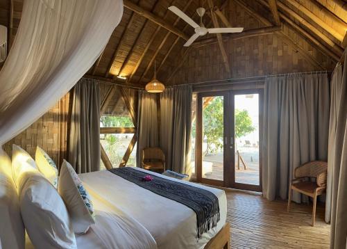 a bedroom with a large bed in a room at The Seraya Resort Komodo in Labuan Bajo
