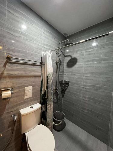 a bathroom with a toilet and a shower at BALAI MALINAWON Hotel 3 in General Luna