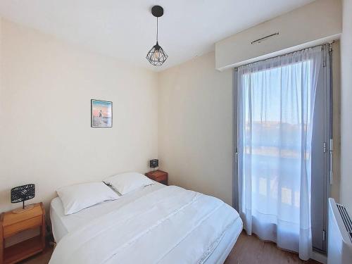 a bedroom with a bed and a large window at T2 avec loggia, Résidence avec piscine à Vieux-Boucau - FR-1-857-7 in Vieux-Boucau-les-Bains