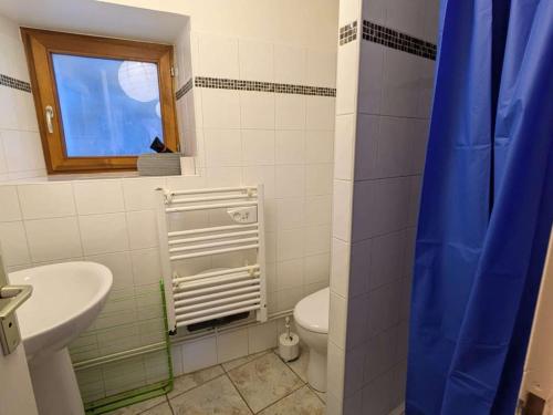 a bathroom with a sink and a toilet and a window at Charmant T2 au centre avec parking et WIFI - FR-1-342-340 in Arêches
