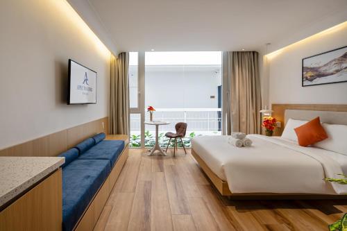 a hotel room with a bed and a table at APEC WANDER HOTEL - Near Pink Church in Ho Chi Minh City