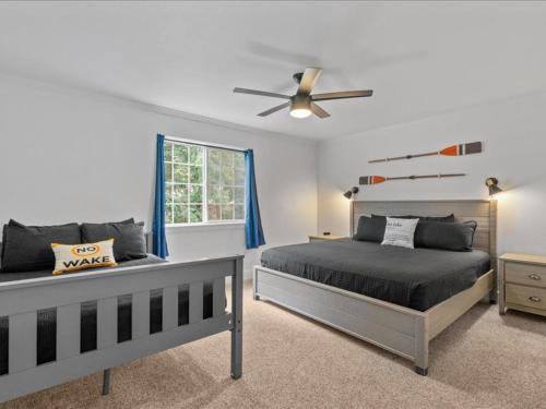a bedroom with two beds and a ceiling fan at Lake, Hot Tub, Golf Retreat in Hayden Lake