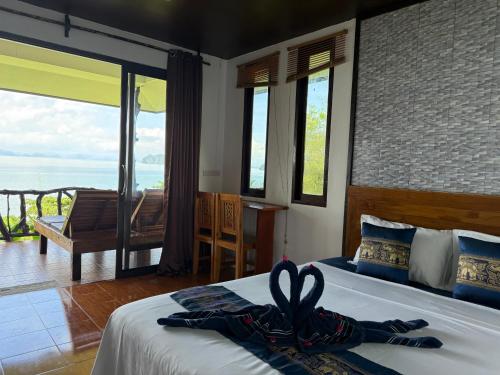 a bedroom with a bed with a towel on it at Phu Samut in Ban Ba Kan Pa