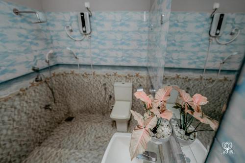 a small bathroom with a toilet and a sink at Lotus Udawalawe in Udawalawe