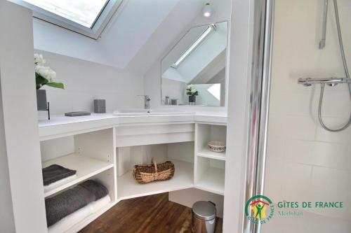 a bathroom with a sink and a mirror at Gite de kermativan in La Trinité-Surzur
