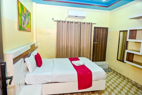a bedroom with a bed with red and white sheets at Hotel Sun Star International Pvt Ltd in Bhairāhawā