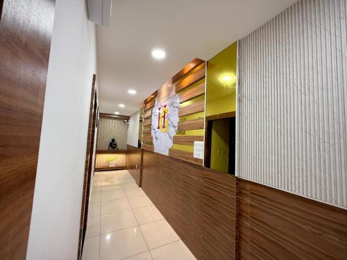 a hallway of a building with a flag on the wall at The Grand's in Jagādhri