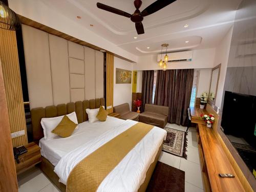a hotel room with a large bed and a television at The Grand's in Jagādhri
