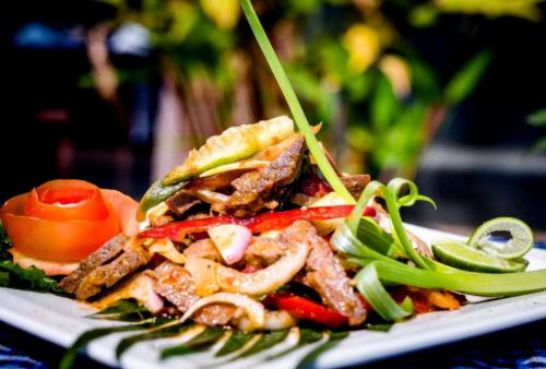 ein Teller mit Essen, bestehend aus einem Sandwich und Gemüse in der Unterkunft Indochine Sanctuary Boutique Hotel in Siem Reap