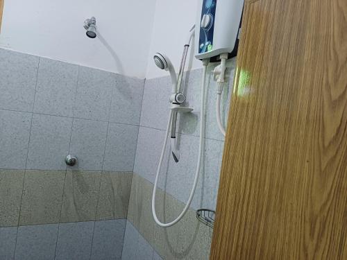 a shower with a shower head in a bathroom at Elephant View Hotel in Damana