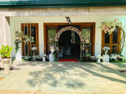 an entrance to a wedding with an arch and flowers at Elephant View Hotel in Damana