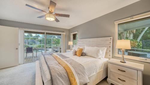 a bedroom with a bed and a ceiling fan at Gulf Birdie - 5551 in Siesta Key