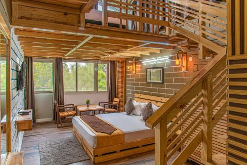 a bedroom with a large bed and a staircase at Luxury Kasauli Skyline 2BHK Apartment with Jacuzzi and Mountain View in Kasauli