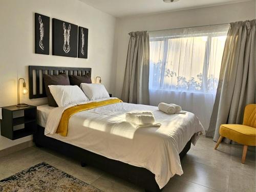 a bedroom with a large bed and a window at ONE on Michelle in Ballito