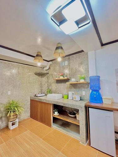 a kitchen with a counter with a sink in it at Precious Homestay - Serenity Room in Burgos