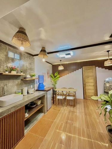 a kitchen with a table and a dining room at Precious Homestay - Serenity Room in Burgos