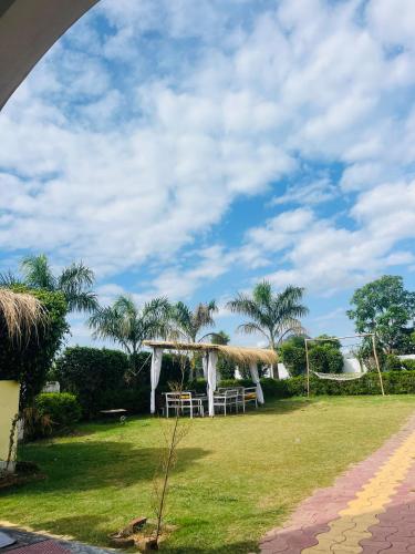 a resort with a table and chairs in a field at Heaven hill Pushkar in Pushkar
