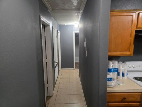 a kitchen with a hallway leading to a kitchen with a sink at fancy wonderful home! in Houston