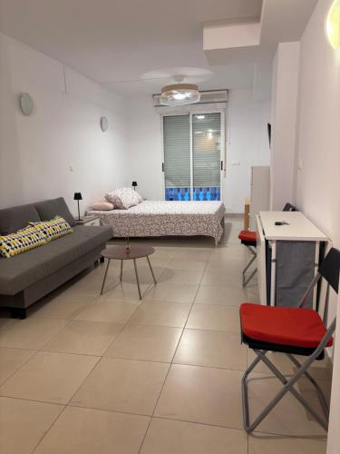 a living room with two beds and a couch at Beach Apartament Playa in El Campello