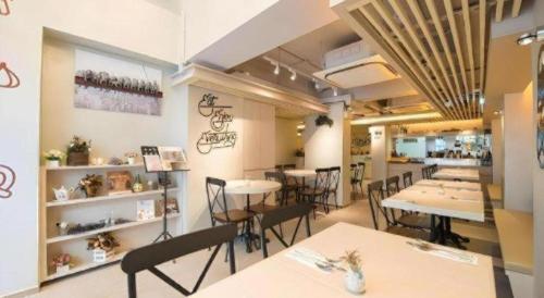 a restaurant with tables and chairs in a room at Metroplace Boutique in Hong Kong
