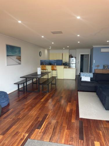 a living room with a table and a couch at Cowes Beachfront Retreat in Cowes