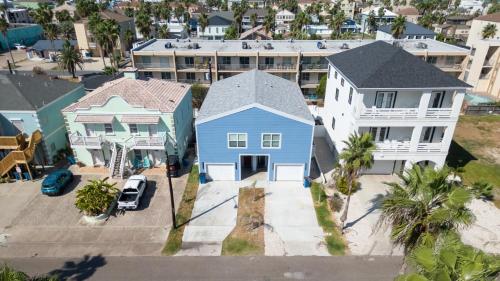 an aerial view of a house with a blue house at 200 Steps to Beach Private Pool 2 Big Levels apts in South Padre Island