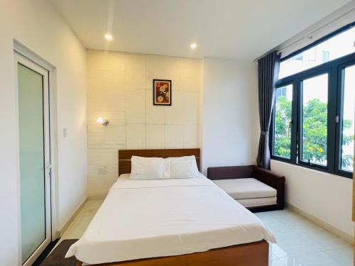 a bedroom with a large bed and a window at Bona Hostel in Da Nang