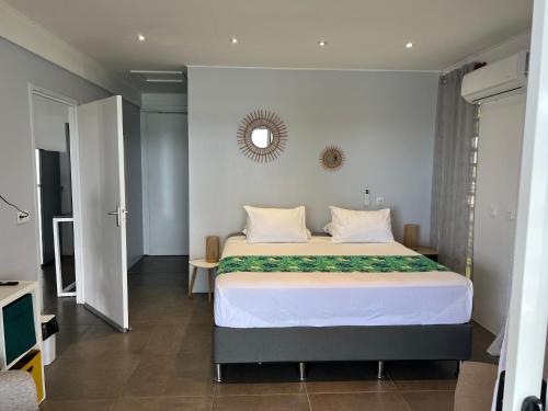 a bedroom with a large bed with a mirror on the wall at Blue Essence Tahaa in Tahaa