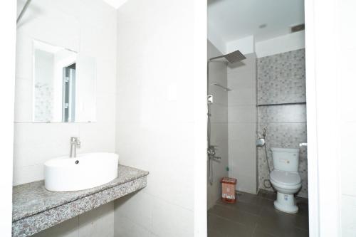 a bathroom with a sink and a toilet at Bona Hostel in Da Nang